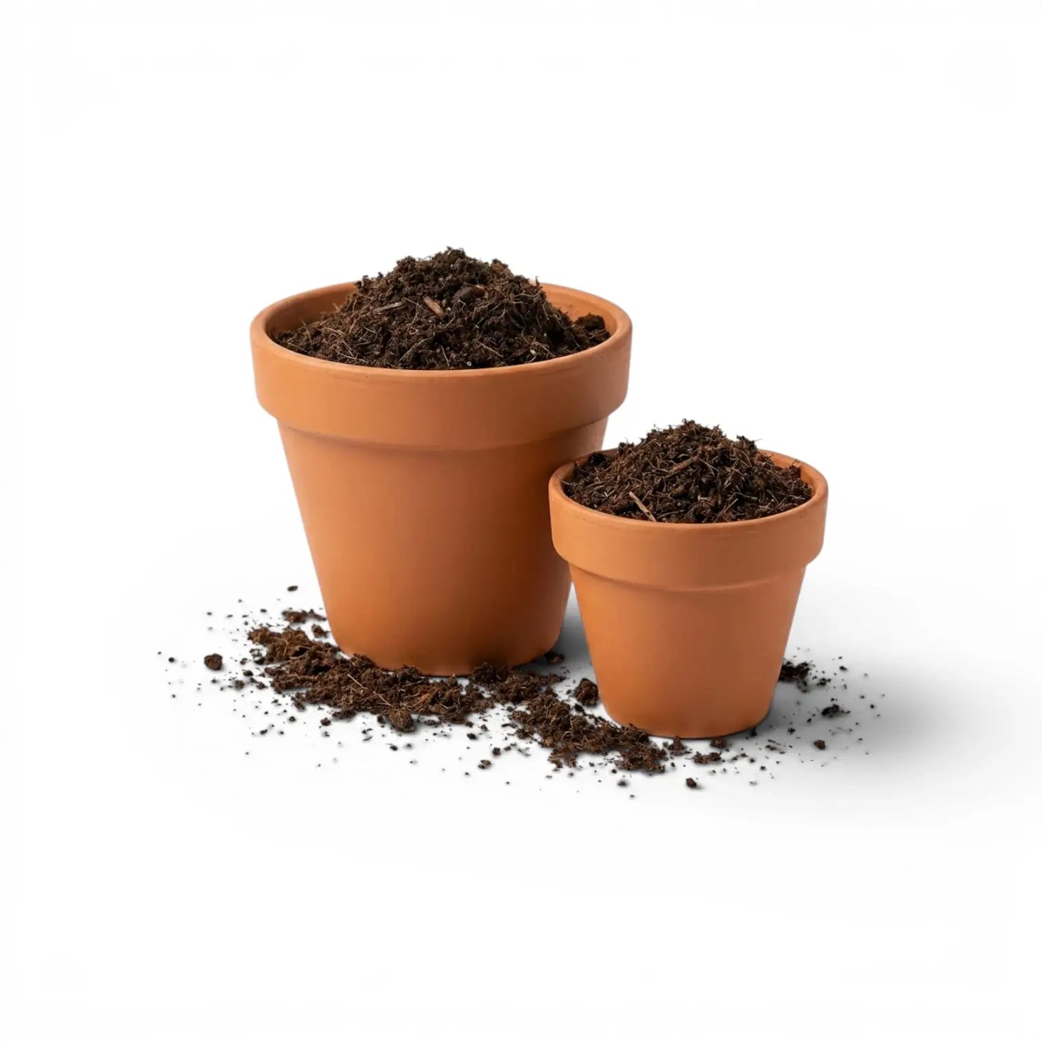 Two terracotta pots filled with soil on a white background