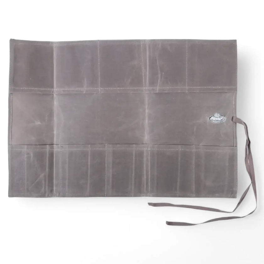 Waxed canvas roll up pouch on white background.