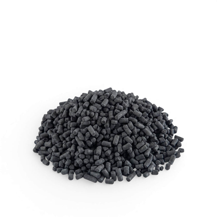 Pile of activated carbon pellets on a white background