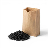 Brown paper bag filled with black activated carbon pellets on a white background