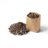 Brown paper bag filled with cacti and succulent potting mix on a white background