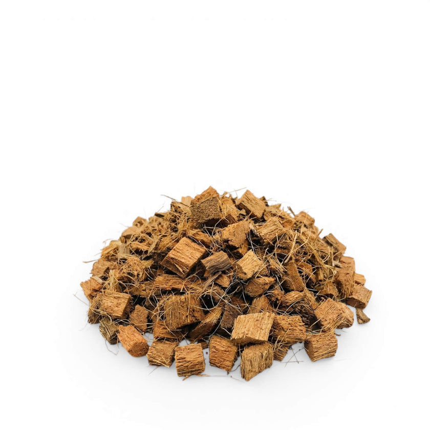 Pile of brown coconut coir chips on a white background