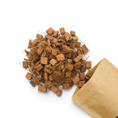 Coconut coir chips with a brown paper bag on a white background