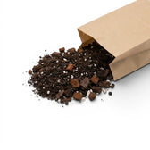 Brown paper bag with Hoya potting mix spilling out on a white background