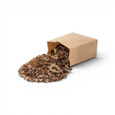 Open brown paper bag filled with orchid potting mix on a white background