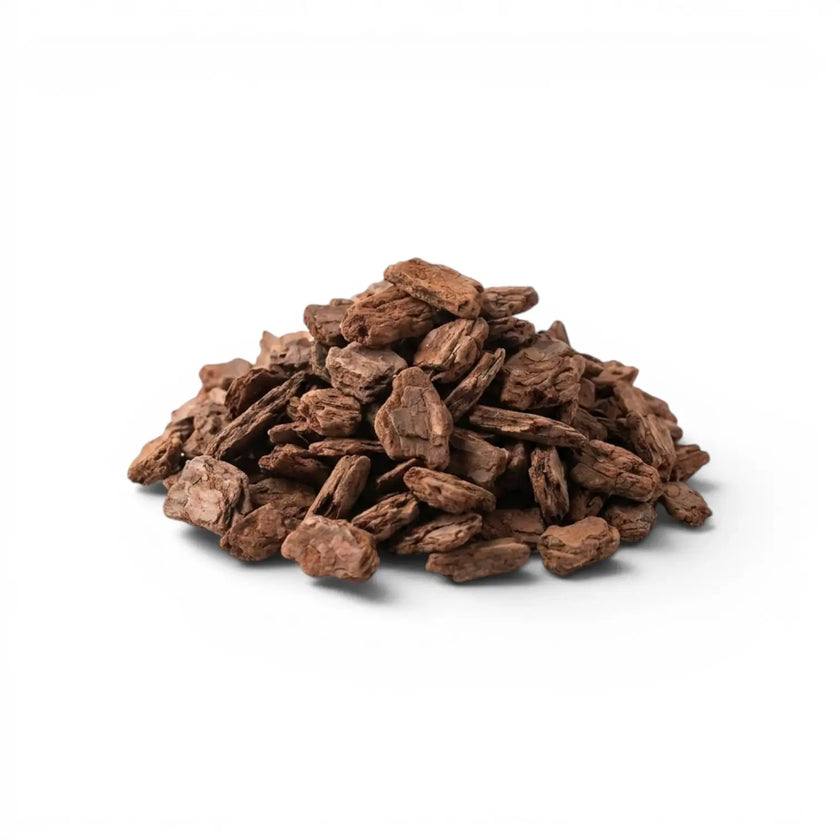 Pile of brown pine bark chips on a white background