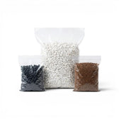 Three bags of different terarrium substrate layers - activated carbon pellets, white gravel stones and coconut coir soil on a white background
